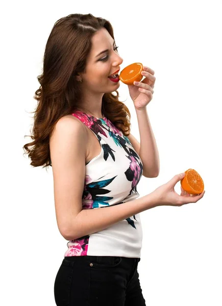 Beautiful young girl holding oranges — Stock Photo, Image