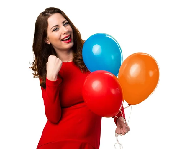 Suerte hermosa joven sosteniendo globos — Foto de Stock