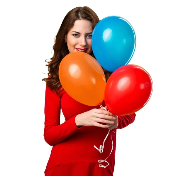 Feliz hermosa joven sosteniendo globos — Foto de Stock