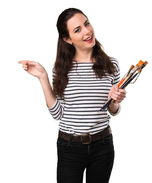 Young artist woman pointing to the lateral — Stock Photo, Image