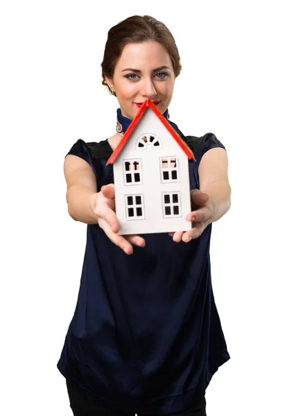 Happy Pretty stewardess holding a little house — Stock Photo, Image