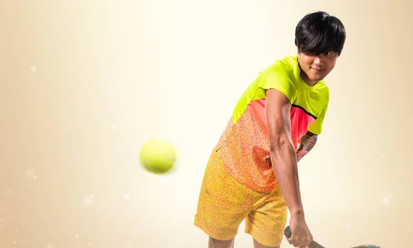 Asian tennis player man on ocher background — Stock Photo, Image
