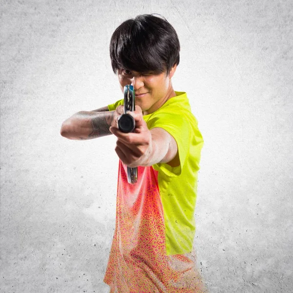Asiático tenis jugador hombre en texturizado fondo — Foto de Stock
