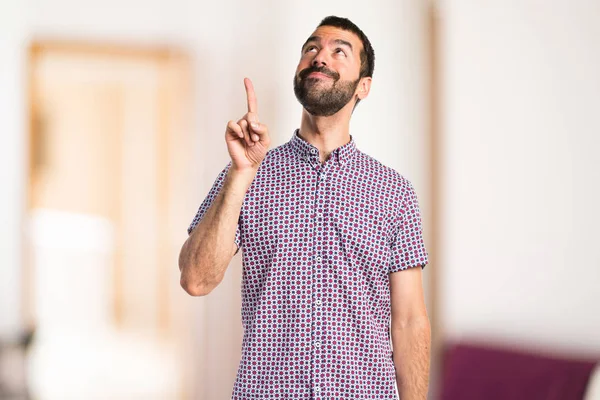 Handsome man pointing up