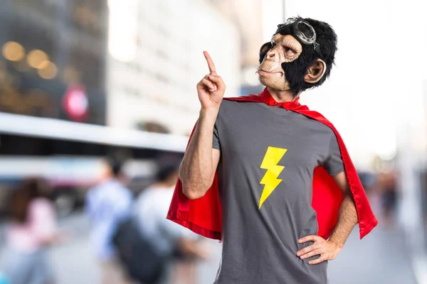 Superhero monkey man pointing up