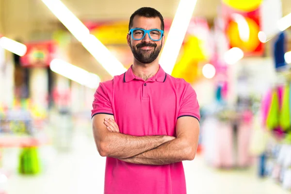 Mannen i färgglada kläder med armarna korsade — Stockfoto