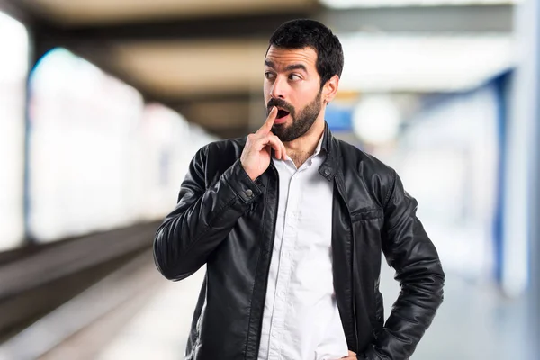 Man with leather jacket doing surprise gesture — Stock Photo, Image