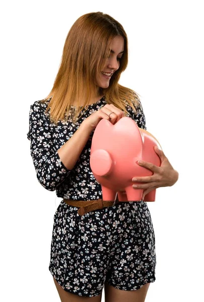 Beautiful young girl holding a piggybank — Stock Photo, Image