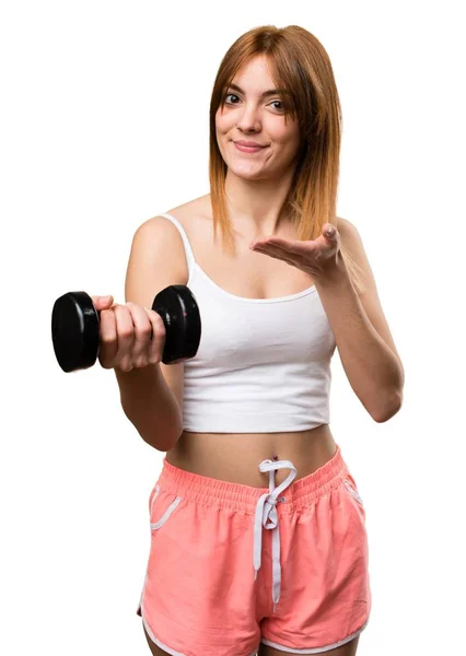 Beautiful sport woman presenting the dumbbell — Stock Photo, Image