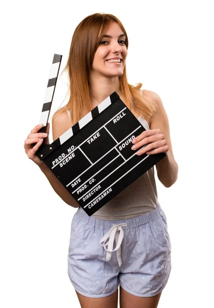 Beautiful girl in pajamas holding a clapperboard — Stock Photo, Image