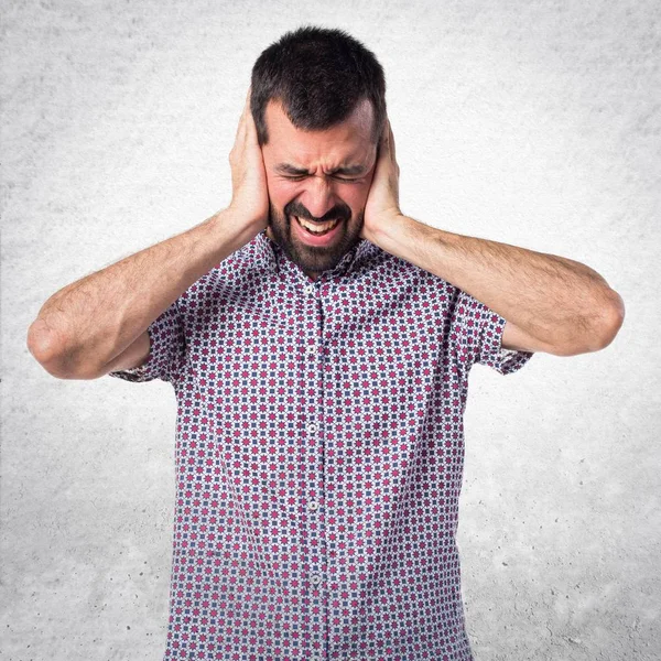 Handsome man covering his ears — Stock Photo, Image