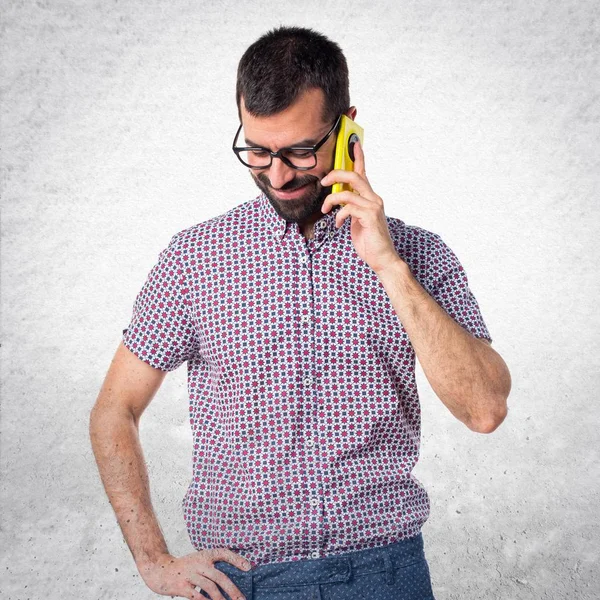 Man with glasses talking to mobile — Stock Photo, Image