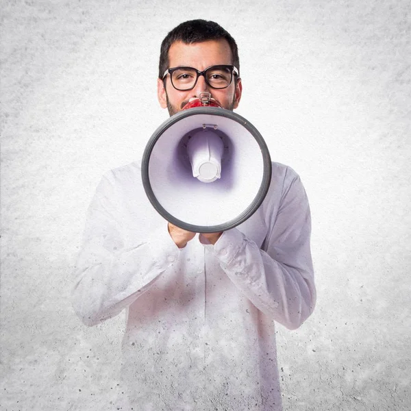 Schöner Mann mit Brille ruft per Megafon — Stockfoto