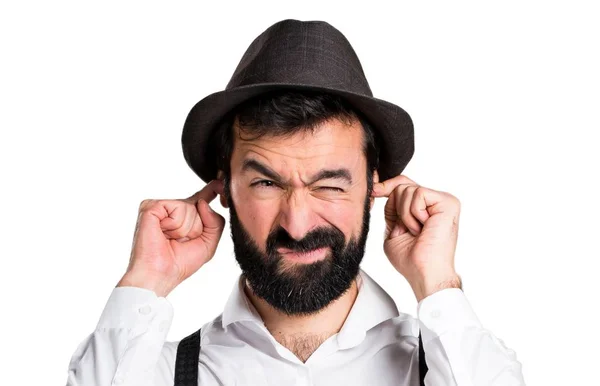 Hipster man with beard covering his ears — Stock Photo, Image