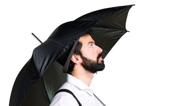 Hipster man with beard holding an umbrella — Stock Photo, Image