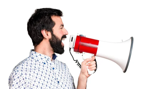 Hombre guapo morena con barba gritando por megáfono — Foto de Stock