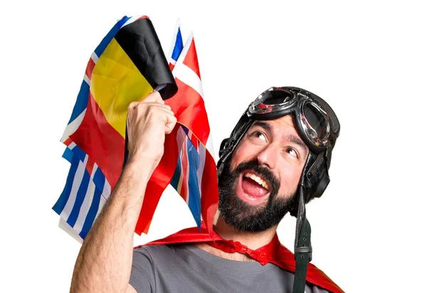 Suerte superhéroe con un montón de banderas —  Fotos de Stock