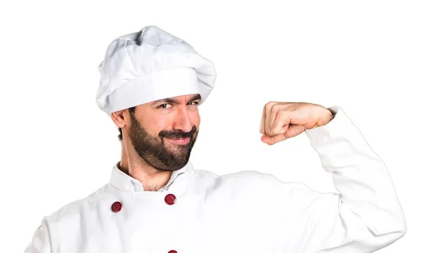 Junge Bäckerin hält Brot in der Hand und macht starke Geste — Stockfoto