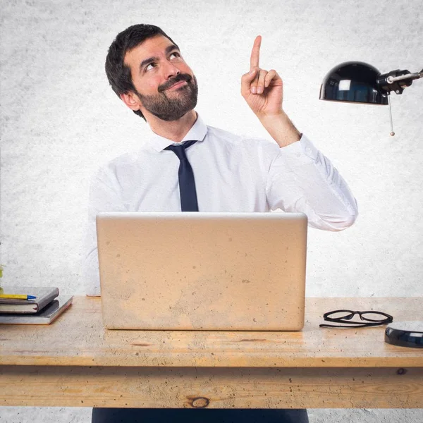 Geschäftsmann in seinem Büro zeigt nach oben — Stockfoto