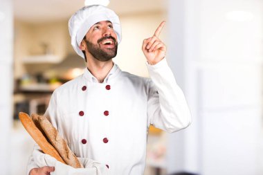 Biraz ekmek tutarak ve mutfakta düşünme genç baker