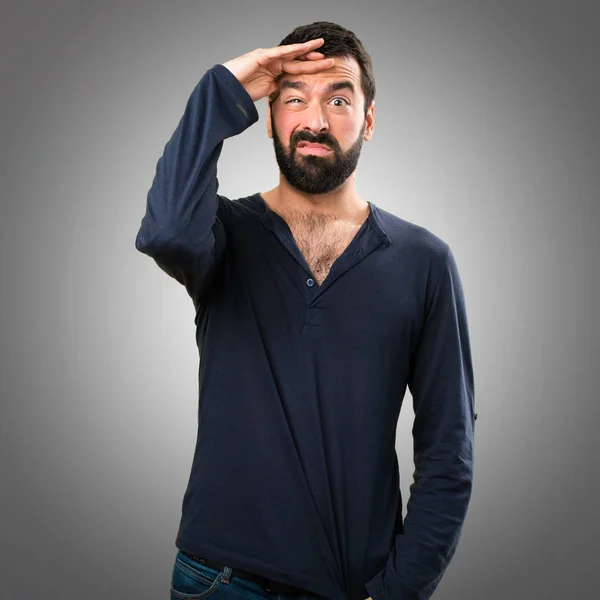 Moe van de knappe man met baard op grijze achtergrond — Stockfoto