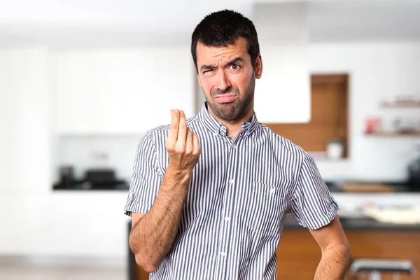 Bonito homem fazendo gesto de dinheiro dentro de casa — Fotografia de Stock