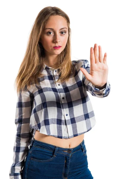 Blonde teen girl making stop sign on textured background — Stock Photo, Image