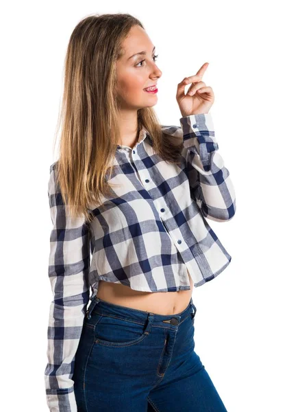 Loira adolescente menina apontando para cima no fundo texturizado — Fotografia de Stock