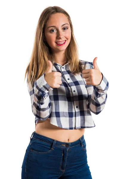 Blonde teen girl with thumb up on textured background — Stock Photo, Image