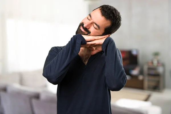 Handsome man with beard making sleep gesture inside house — Stock Photo, Image