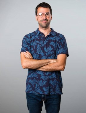 Gri arka plan üzerinde gözlüklü esmer adam