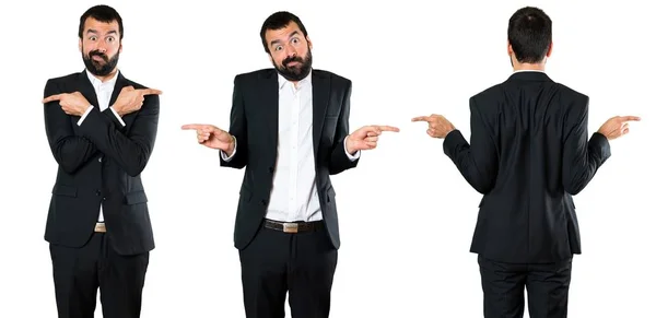 Set of Handsome businessman pointing to the laterals having doubts — Stock Photo, Image