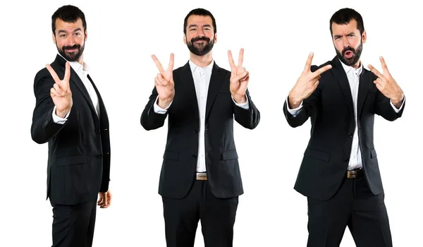 Conjunto de hombre de negocios guapo haciendo gesto de victoria —  Fotos de Stock