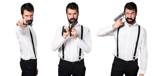 Hipster man with beard with a pistol — Stock Photo, Image