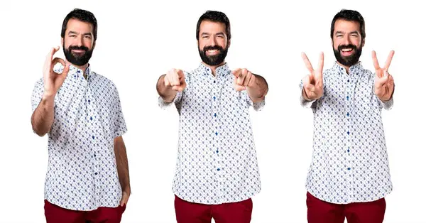 Öne doğru işaret eden sakallı yakışıklı esmer adam