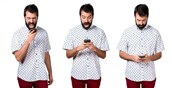 Handsome brunette man with beard talking to mobile — Stock Photo, Image