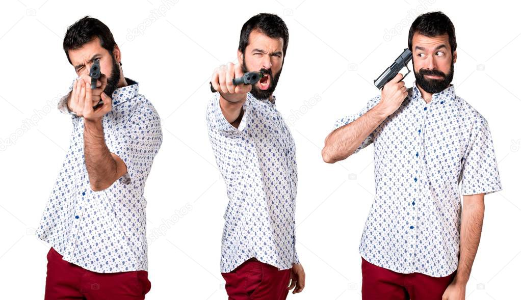 Handsome brunette man with beard holding a pistol