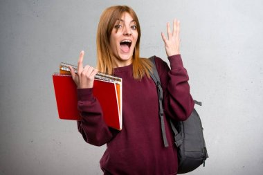 Öğrenci kadın yapma sürpriz jest gri arka plan üzerinde