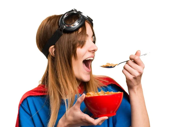 Jolie fille super héros mangeant des céréales d'un bol — Photo