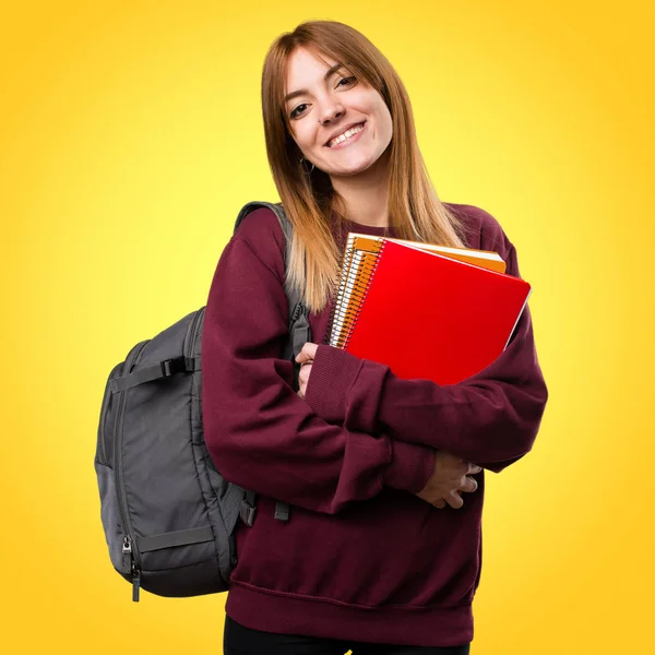 Mujer estudiante feliz en fondo colorido —  Fotos de Stock