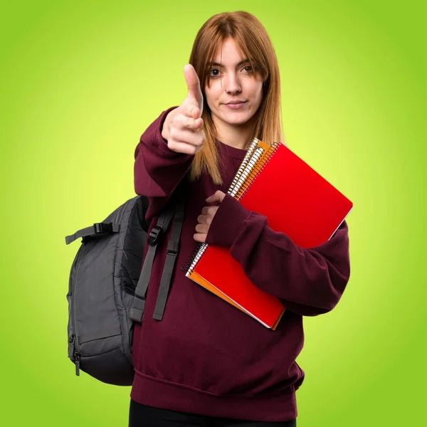 Estudante mulher fazendo gesto arma no fundo colorido — Fotografia de Stock