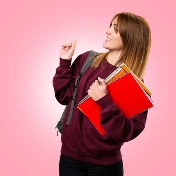 Estudiante mujer apuntando hacia atrás en fondo colorido —  Fotos de Stock