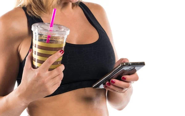 Sport woman with her mobile and her sport drink — Stock Photo, Image