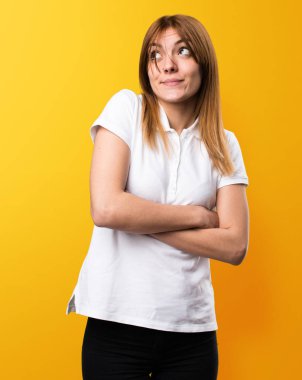 Güzel genç kız üzerinde sarı backgr önemsiz jest yapma