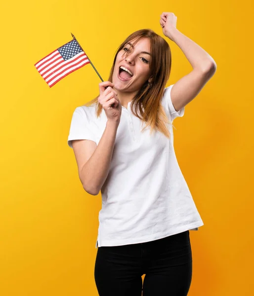 Feliz hermosa joven sosteniendo una bandera americana en amarillo ba —  Fotos de Stock