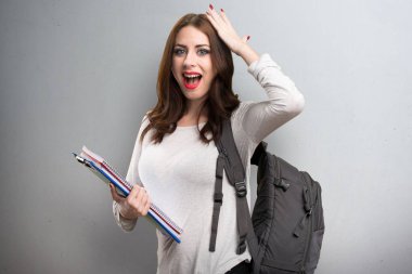 Sürpriz bir jest yapma öğrenci kadın dokulu arka plan