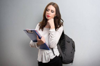 Öğrenci kadın dokulu arka plan üzerinde düşünme