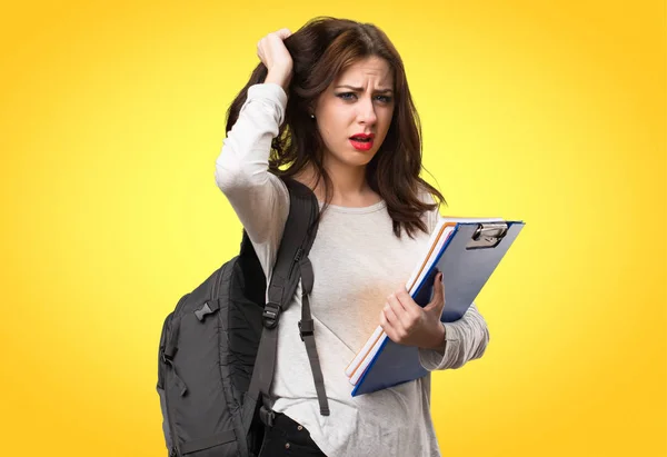 Frustrated student woman on colorful background — Stock Photo, Image
