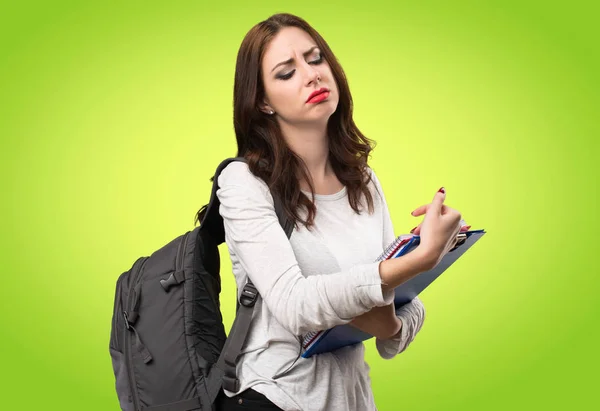 Tired student woman on colorful background — Stock Photo, Image