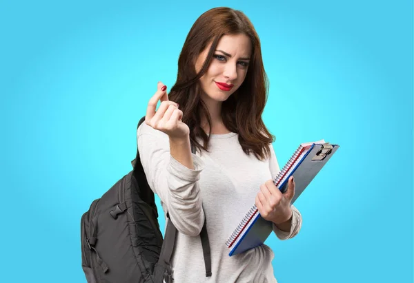 Estudiante mujer haciendo gesto de dinero en fondo colorido —  Fotos de Stock